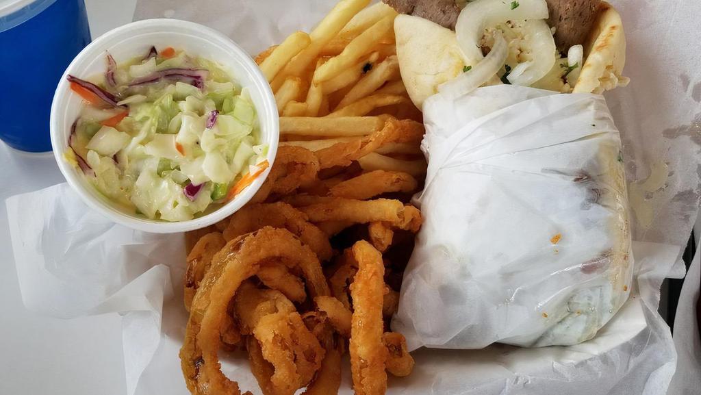 Gyros Plate (No Pita) · A half pound of tender juicy gyros meat freshly cut from the rotisserie. Topped with tomato, onion and out homemade tzatziki sauce. Get any sandwich in a basket, includes fries, onion rings, and coleslaw.