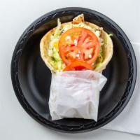 Grecian Grilled Chicken · Marinated grilled chicken breast wrapped in a grilled pita bread topped with lettuce, tomato...