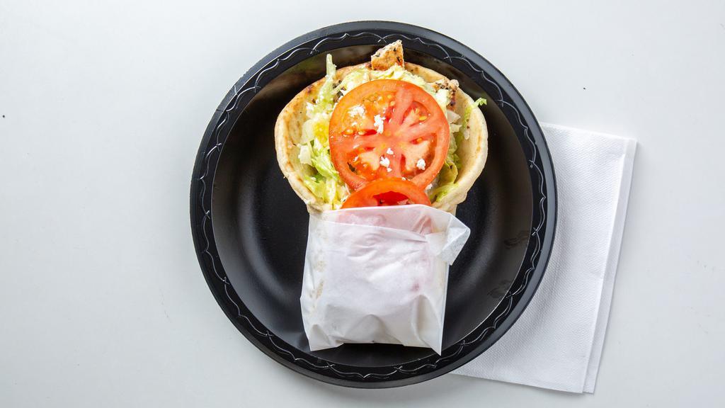 Grecian Grilled Chicken · Marinated grilled chicken breast wrapped in a grilled pita bread topped with lettuce, tomato, feta cheese and our vinaigrette Greek salad dressing. Get any sandwich in a basket, includes fries, onion rings, and coleslaw.