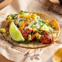 Al Pastor Taco - Single · Pork marinated with fresh pineapple and onion in a mild homemade Guajillo salsa, topped with...