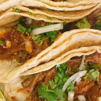 Barbacoa Taco - Single · Slow-cooked beef tacos simmered with ancho, guajillo and arbol chile peppers. Topped with fr...