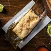 Braised Chicken Tamal · A style of tamales from the Oaxaca region of southern Mexico,. wrapped in a banana leaf.