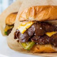 Double · Beef and bacon patty with American cheese, sauce, pickle and lettuce.