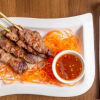 Moo Ping · Grilled marinated pork skewers served with Thai chili dipping sauce.