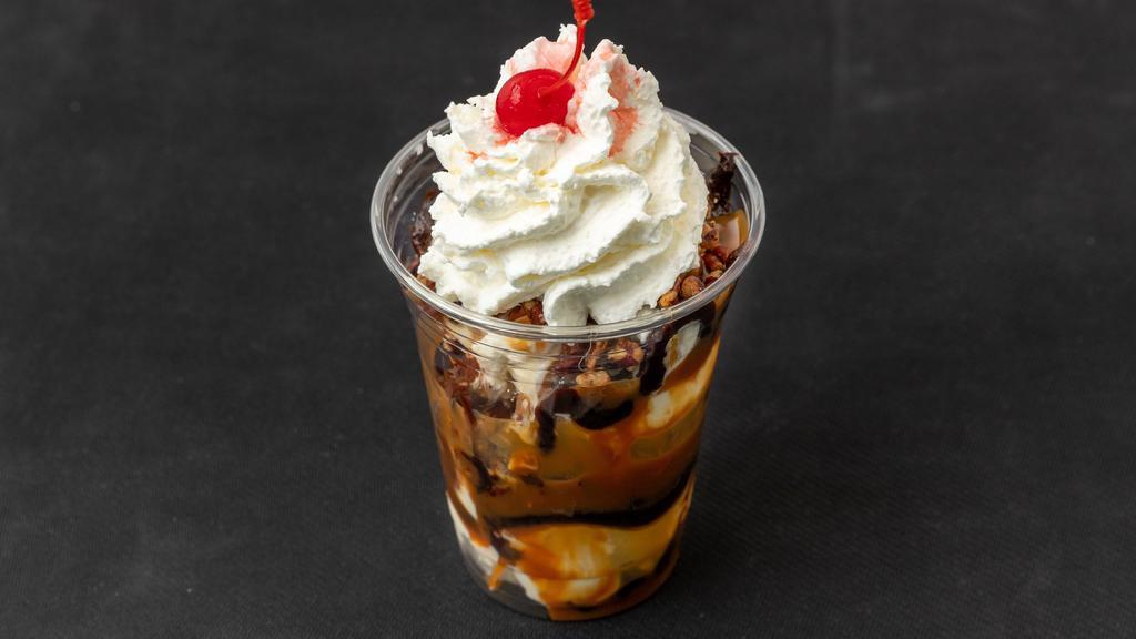 Double Scoop Pecan Turtle Sundae · Two scoops of vanilla ice cream with hot fudge, hot caramel and butter roasted pecans. Then finished with homemade whipped cream and a cherry.
