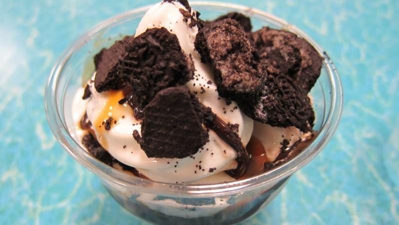 Oreo Sundae · Double scoop. 2 scoops of vanilla ice cream with chocolate syrup and lots of crushed Oreos.  Then finished with homemade whipped cream and drizzled with chocolate syrup.