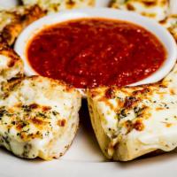 Garlic Cheese Bread · Baguette, mozzarella, and our classic tomato sauce