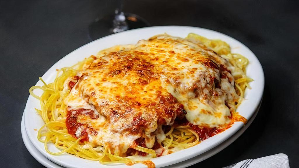 Chicken Parmesan · Parmesan crusted chicken breast served over spaghetti with classic tomato sauce and baked mozzarella