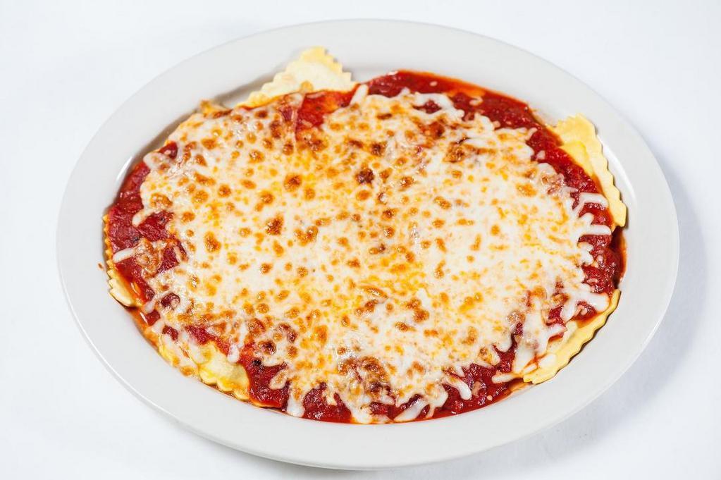 Beef Ravioli · Large ravioli stuffed with beef braised in a Chianti reduction, blended with Asiago and Parmesan with classic tomato sauce and baked mozzarella