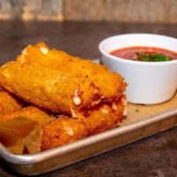 Mozzarella Sticks · Hand cut mozzarella battered and coated in herb breadcrumbs and fried golden brown. Served w...