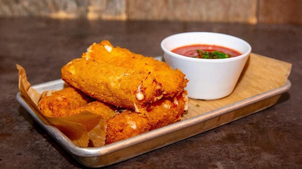 Mozzarella Sticks · Hand cut mozzarella battered and coated in herb breadcrumbs and fried golden brown. Served with marinara sauce.