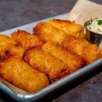 House Made Tots · Freshly grated russet potatoes combined with onion, salt, pepper and fried to a golden brown...