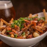 Poutine · Hand-cut fries, bacon, pork belly gravy, gouda cheese sauce, cheese curds and scallions. Gra...