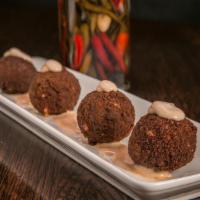 Reuben Balls · Corned beef, Swiss bechamel sauce and kraut rolled in marble rye bread crumbs. Served with o...