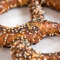 Everything Pretzel (Large) · The everything pretzel is topped with sesame seeds, poppy seeds, caraway seeds, garlic, onio...