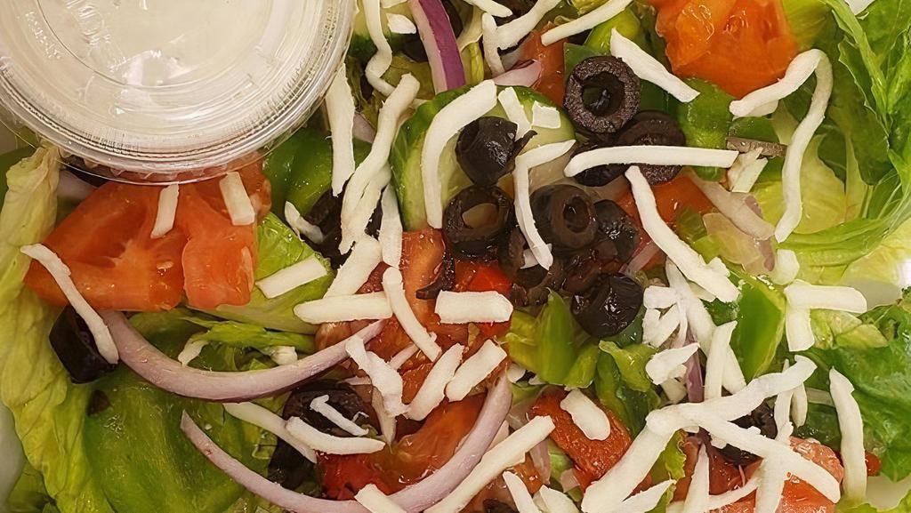 Garden Salad · Romaine lettuce, tomato, cucumber, black olives, red onions, green bell peppers and mozzarella. Served with a Parmesan baked bread stick and your choice of house-made dressing.