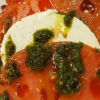 Mozzarella Caprese · Fresh Mozzarella layered with ripe tomato and fresh basil pesto, sprinkled with a bit of Ita...