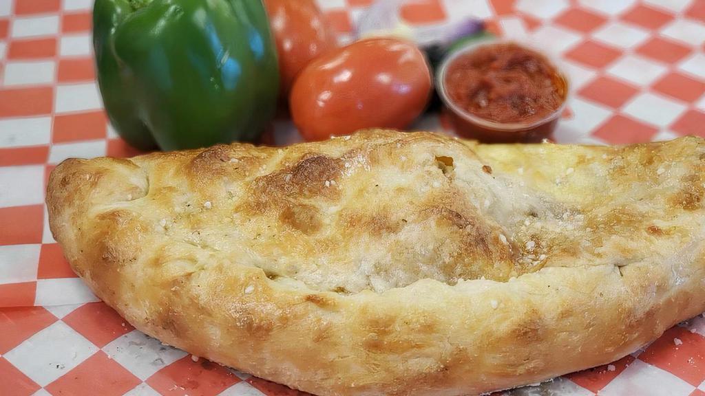 Calzone · Ya gonna score wit dis one! Like a football cut in half! A big, golden pizza dough turnover filled wit’ ricotta and Mozzarella cheeses and any other fillings you want.