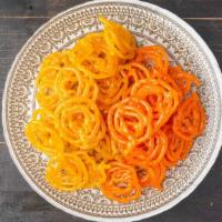 Orange Jalebi (1 Lb) · Fried orange colored funnel cake with nuts, dipped in sugar syrup & served. (Allergens-Tree ...