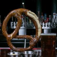 The Bf Pretzel · BurgerFin favorites. Giant Bavarian pretzel served with fat tire beer cheese and stone groun...