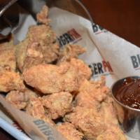 Boneless Wings · Marinated chicken tender bites, seasoned and fried to a golden brown. Served with your choic...