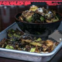 Crispy Brussel Sprouts · Tossed in house-made chile lime sauce and topped with parmesan cheese.
