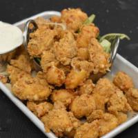 Wisconsin Cheese Curds · Cheese curds, hand-dipped and fried golden brown. Served with our house-made ranch.