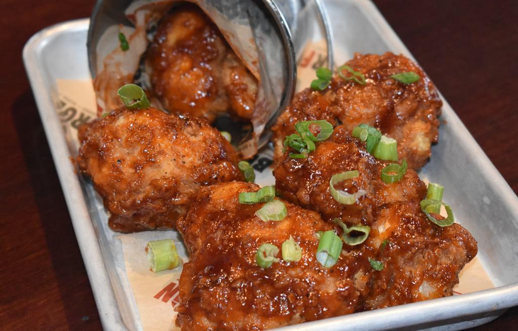 Cauliflower Wings · Cauliflower florets lightly coated and fried golden brown. Tossed with your choice of our BF BBQ sauce or our Asian Bangin' sauce.