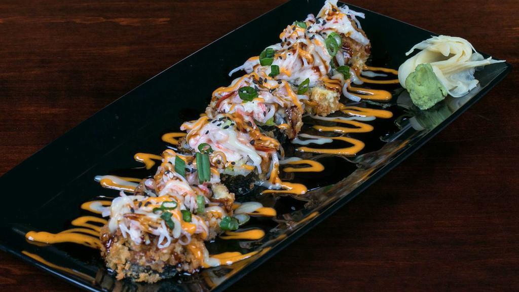 Fin Roll · Salmon, cream cheese, avocado, crab salad and cucumbers, deep fried and topped with crab salad, eel sauce, spicy mayo, wasabi aioli and sesame seeds