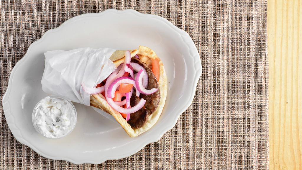 Gyro Pita · Tender lamb slices with tomatoes, onions and cucumber sauce.