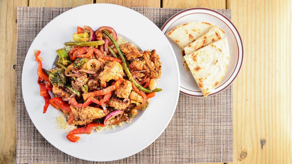 Chicken Stir Fry · A delicious blend of fresh mixed vegetables, stir-fried with chicken served over a bed of rice with pita bread and and your choice of soup, salad, or coleslaw