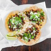 Tacos De Carnitas · Tender Pork Marinated in garlic. fresh lime, orange juices and spices. slow Rosted and serve...