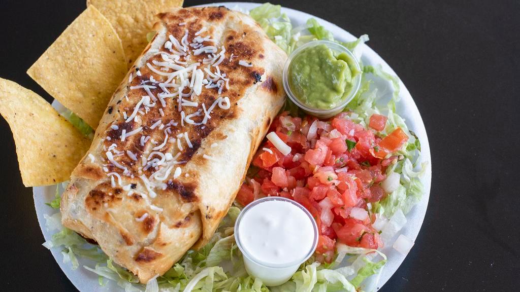 Seafood Burrito · Shrimp and crab meat grilled with onions, tomatoes and bell peppers wrapped in a big tortilla and topped with cheese. Served with rice, beans, lettuce, sour cream and pico de gallo.