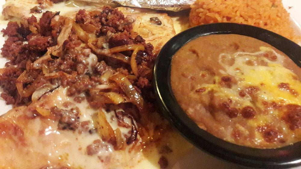 Chory Pollo · A juicy chicken breast grilled with Mexican sausage (chorizo) and onions. Topped with cheese. Served with rice and beans.