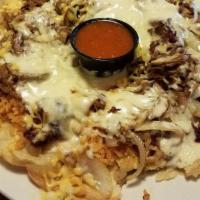 Sombrero · Marinated pork cooked on the grill with onions and mushrooms. Topped with cheese and rice an...