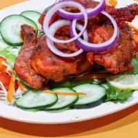 Tandoori Chicken · Chicken marinated in yogurt, herbs, and spices, cooked in tandoor oven.