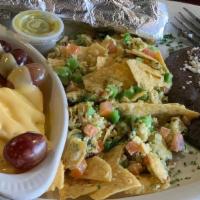 Migas · Two eggs scrambled with corn tortilla chips, tomatoes, jalapeno and cilantro. Served with re...