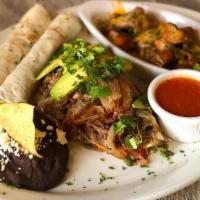 Chapin · The traditional, three soft scrambled eggs served with black refried beans and fried plantai...