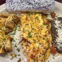 Spanish Omelet · Egg omelet with tomatoes, red bell pepper, chives and onions, stuffed with cheddar cheese an...