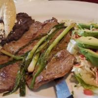 Carne Asada · Grilled beef steak marinated in chimichurri, topped with two green onions, served with rice,...