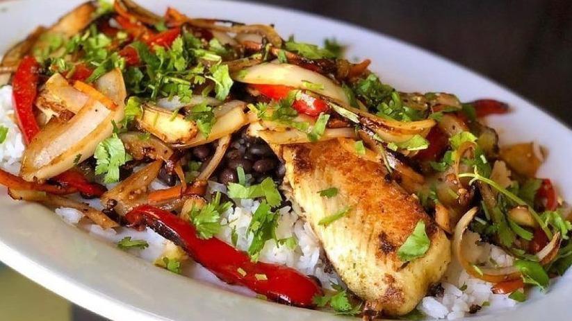 Tilapia · A bed of rice and whole black beans topped with grilled tilapia fillets and sauteed vegetables.