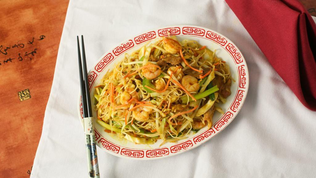 Singapore Noodles · Thin rice noodles mixed with shrimp, pork and vegetables seasoned with curry.