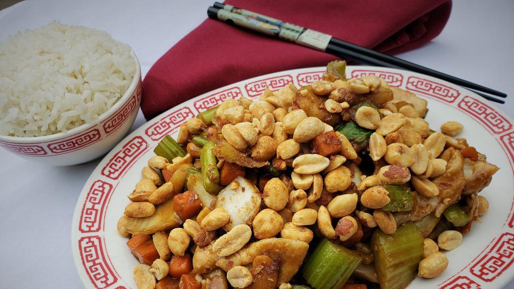Kung Pao Chicken · Chicken stir-fry with diced Chinese vegetables, topped with peanuts in a dark sweet sauce.