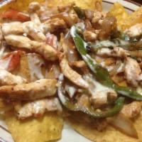 Nachos Locos · Tender grilled chicken, steak, and shrimp served atop bed of tortilla chips covered with shr...