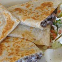 Fiesta Quesadillas · A large flour tortilla with melted cheese, chicken, chorizo and onions. Served with lettuce,...