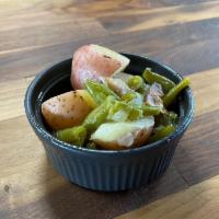 Green Beans And Red Potatoes · These Southern-style beans are cooked for a long time with potatoes, bacon, onion, and our h...