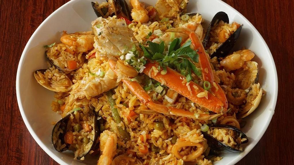 Arroz Marinero · Classic Coastal Ecuadorian Dish, w/ Yellow Rice, Vegetable, Crab Legs, Calamari, Mussels, Clams, Baby Octopus & Tilapia