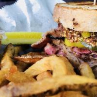 Pastrami Surprise · Grilled pastrami, provolone cheese, sauerkraut, spicy mustard, banana peppers and pickles an...