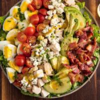 Cobb Salad · Bed of mixed lettuce topped with grilled chicken breast, bacon, hard boiled egg, avocado, to...