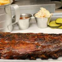 Kansas City Style Ribs · Dry rubbed baby back ribs smoked low & slow, glazed with house made BBQ sauce. Served with C...